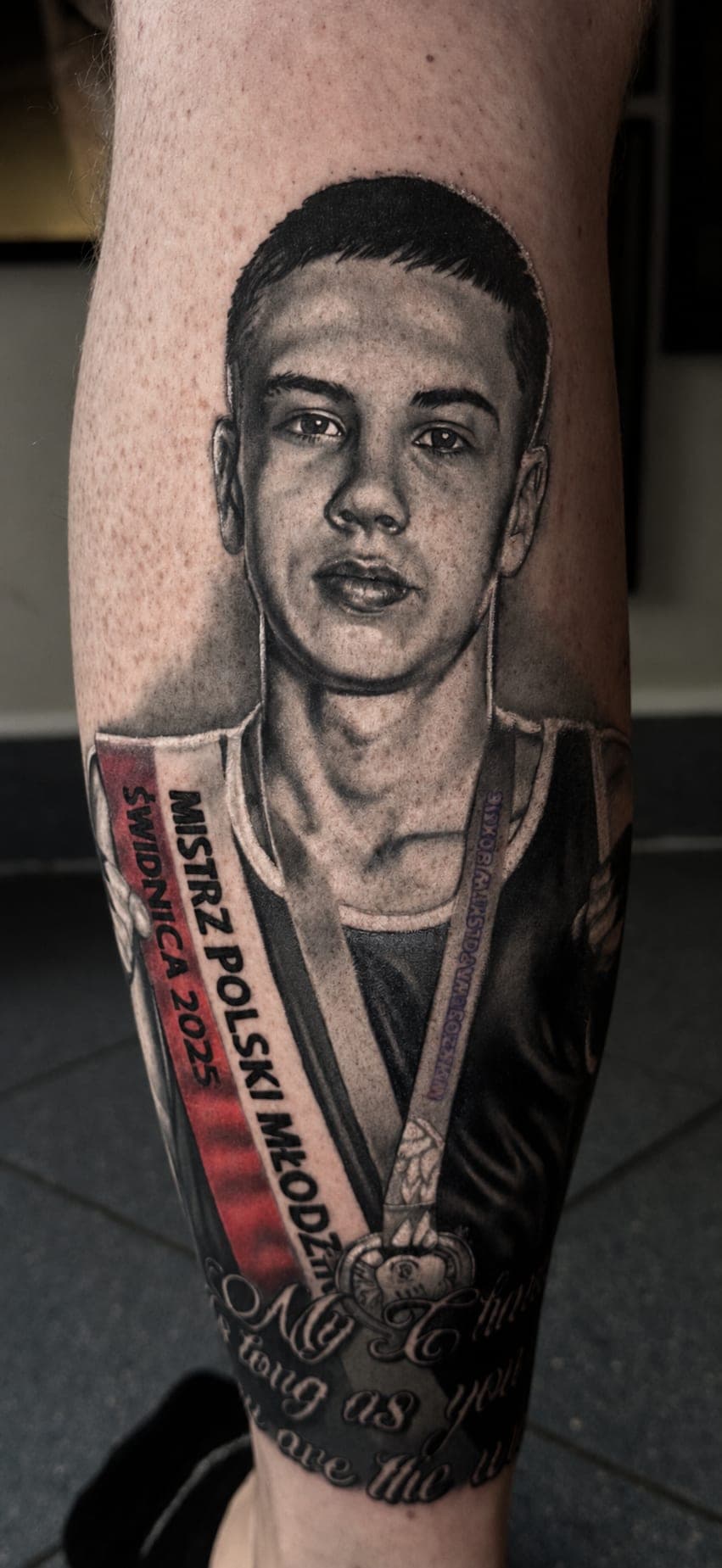 Portret młodego sportowca z szarfą mistrza Polski — realizm black&grey
